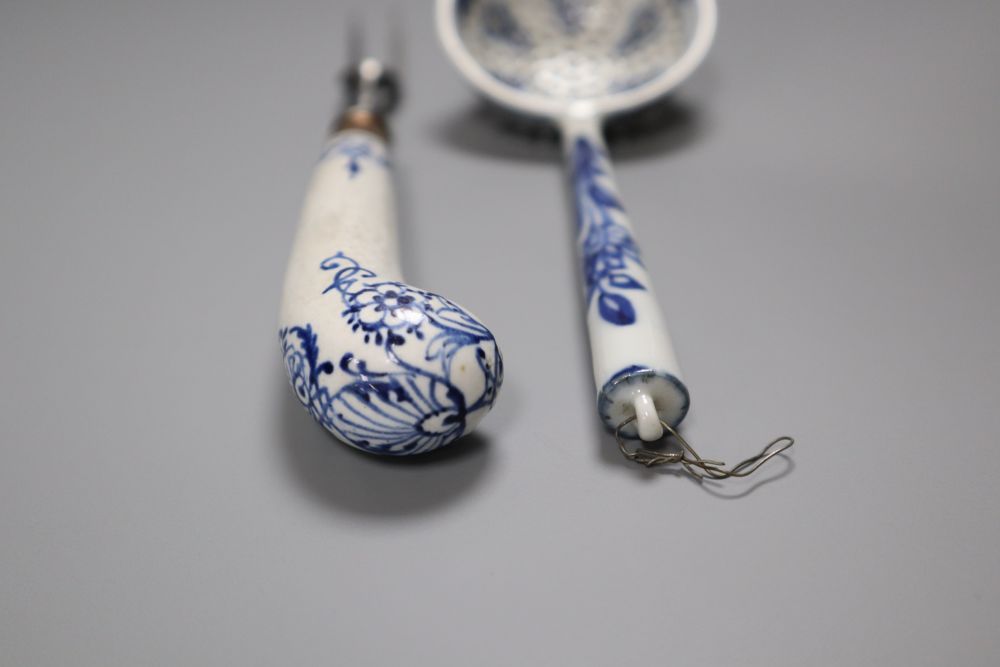 A Bow pistol grip blue and white handled fork, c.1770, 23cm, and a Continental porcelain blue and white strainer ladle, 17cm